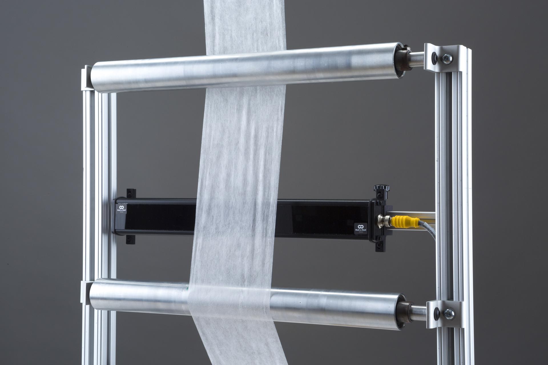 Web width measurement with a single wide sensor showing ODC 384 with a low basis nonwoven web